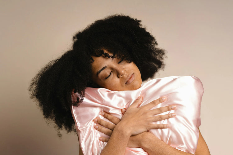 women holding a comfortable silk pillow