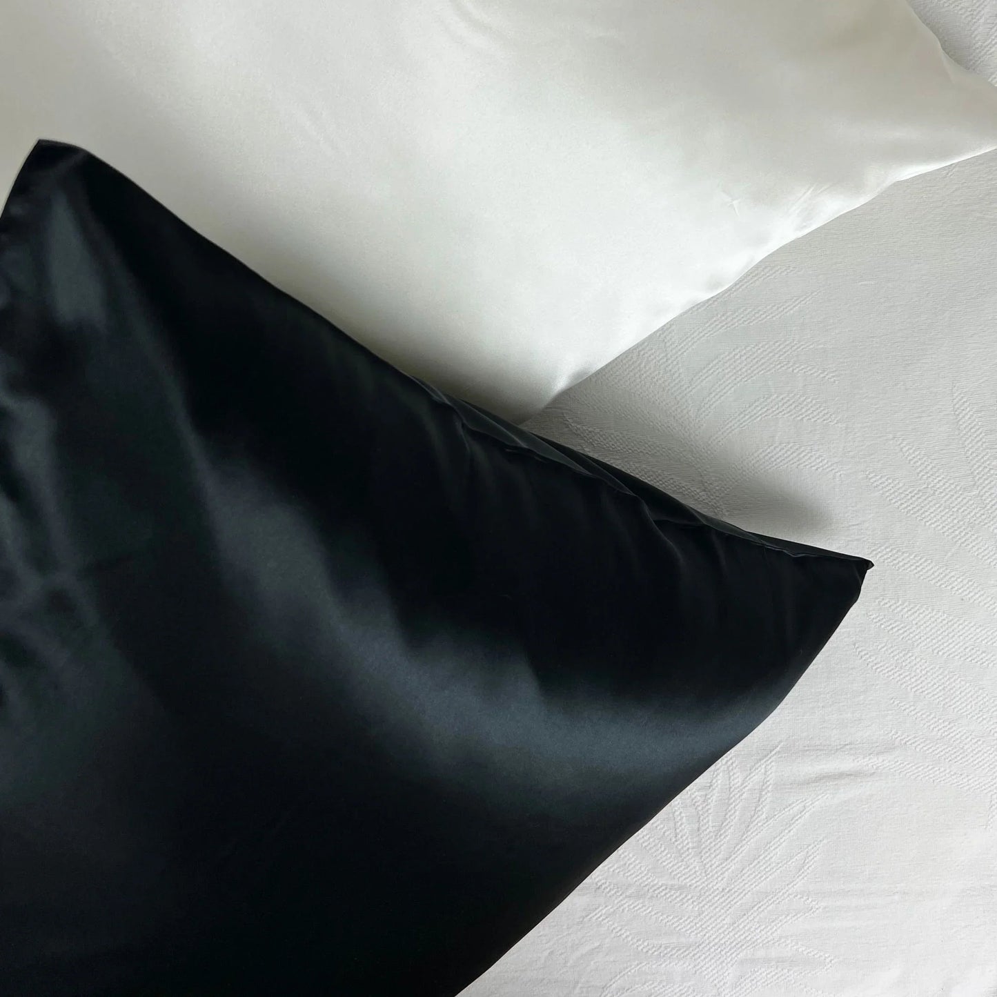 Black silk pillowcase for sleeping on white bedding