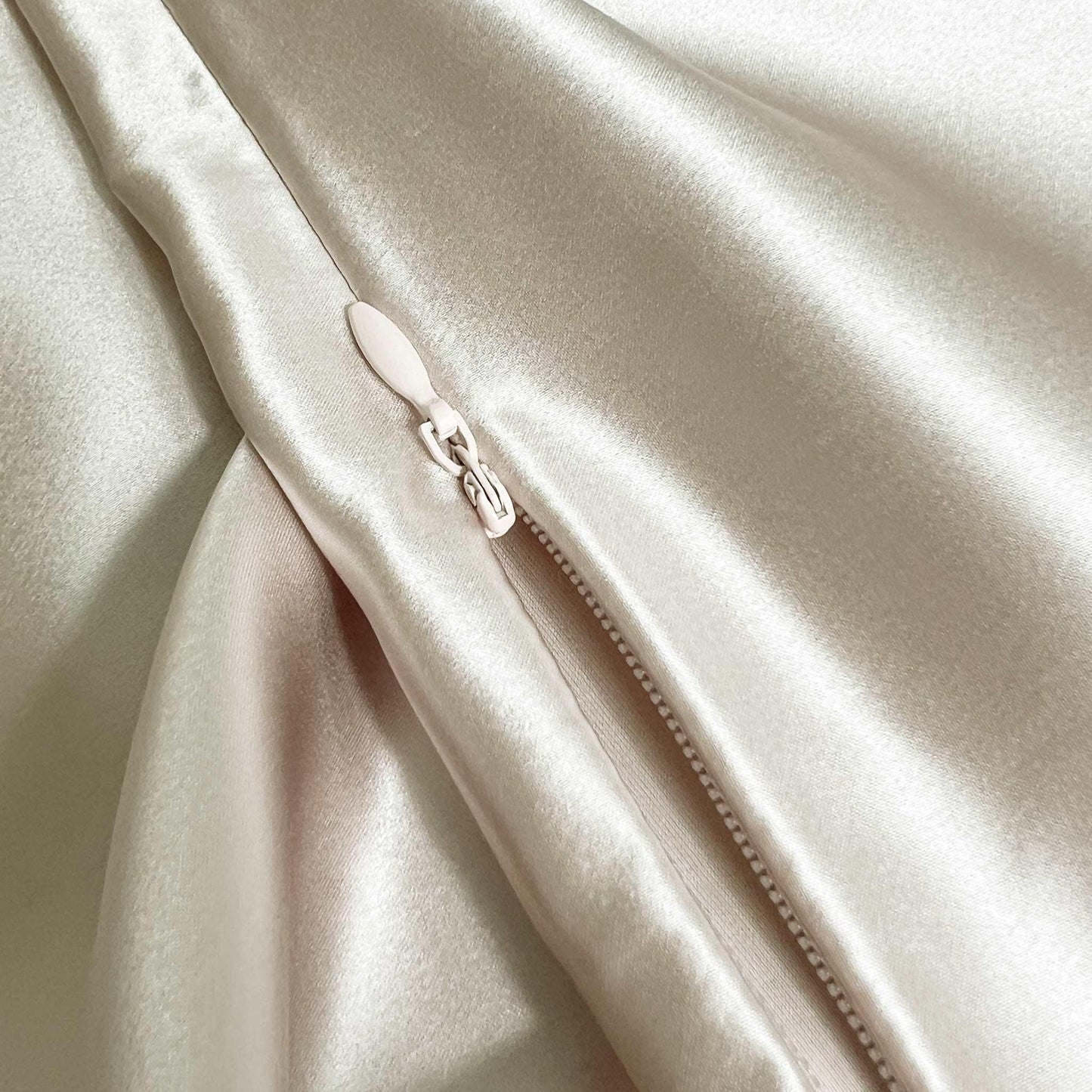 Close-up of a beige champagne fabric with a zipper