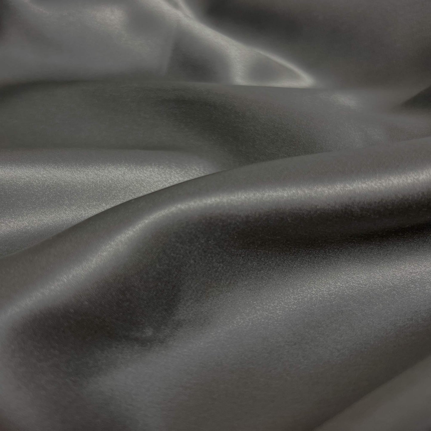 Close-up of gray 100% silk fabric with folds