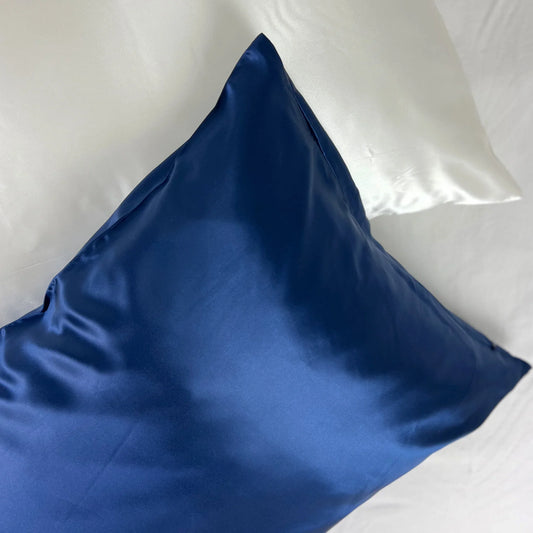 Navy blue silk pillowcase on bed setting