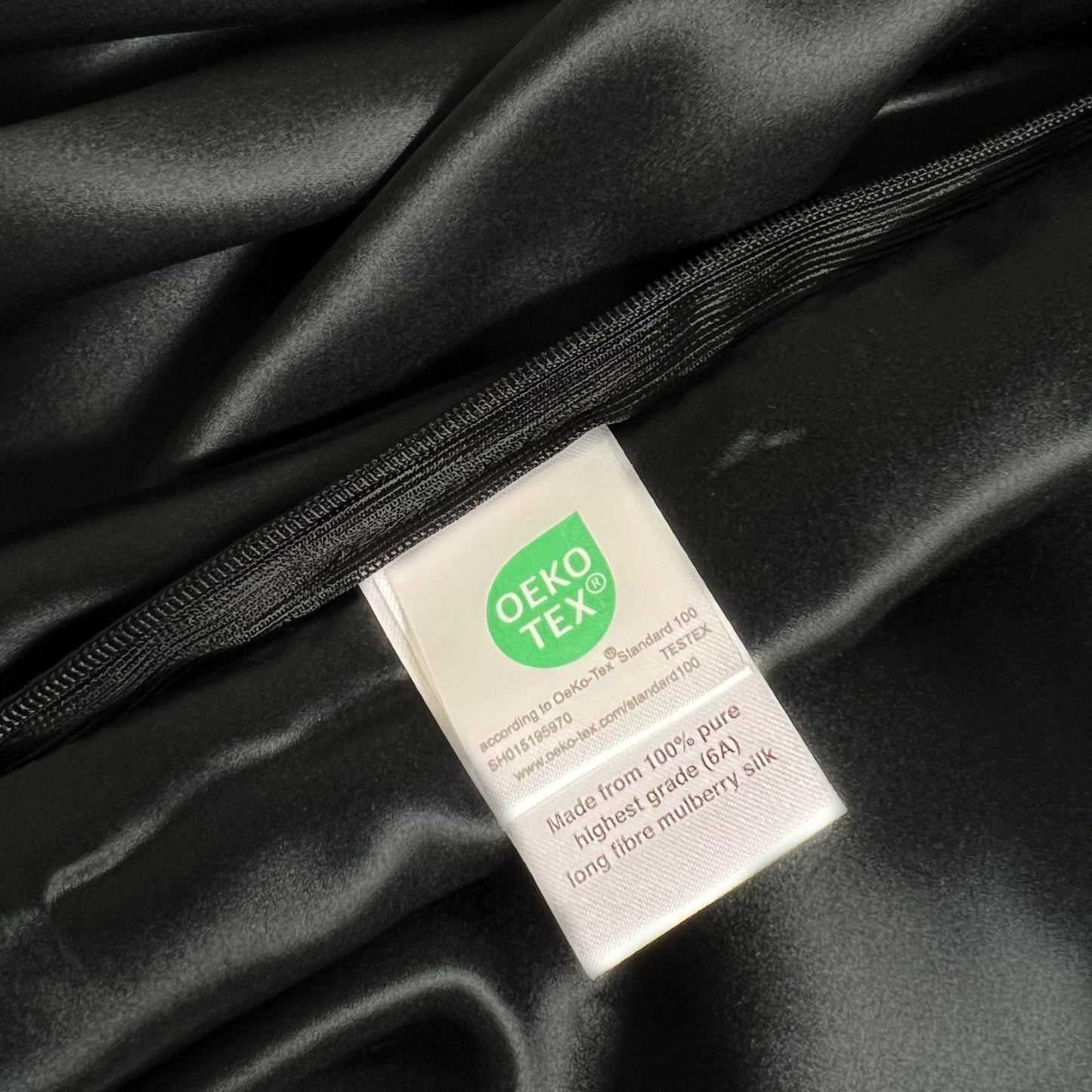 OEKO-TEX label on black silk pillow case