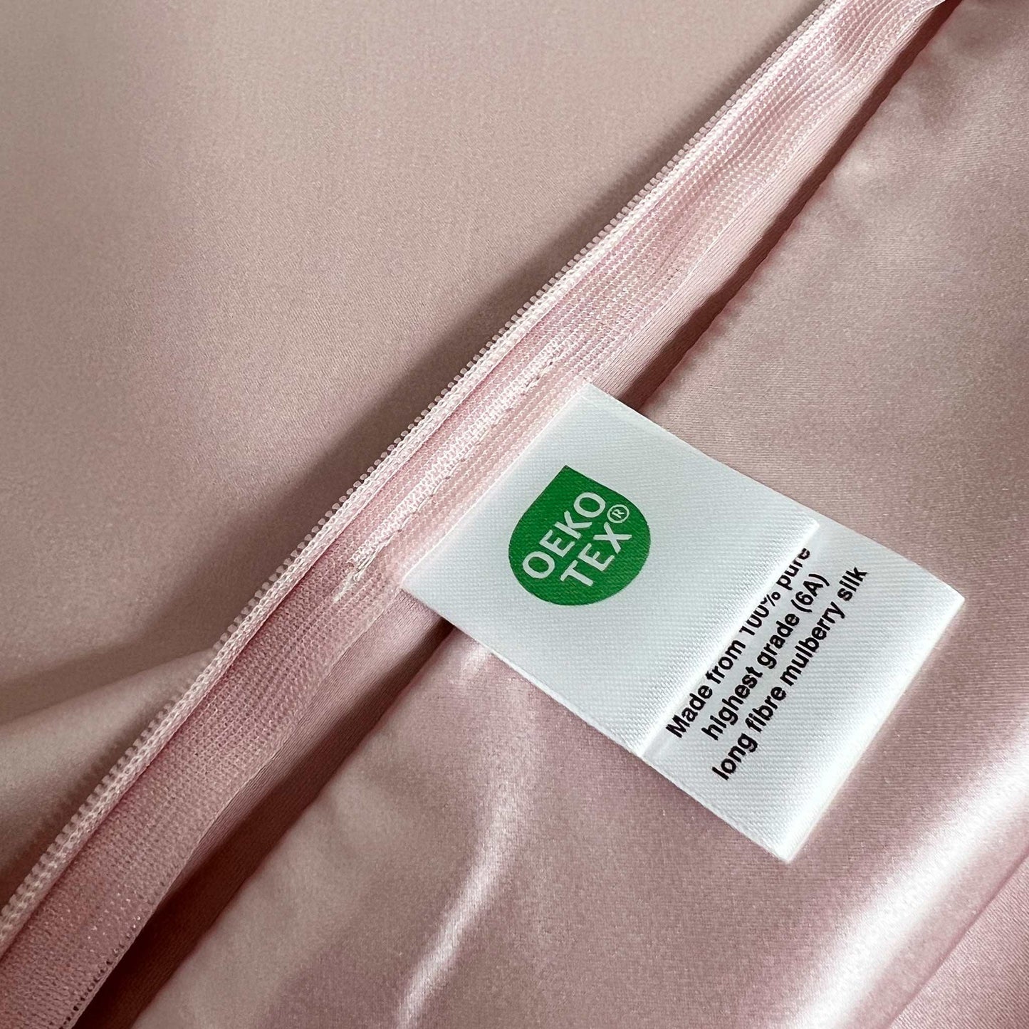 Oeko-Tex label on a pink silk pillow case
