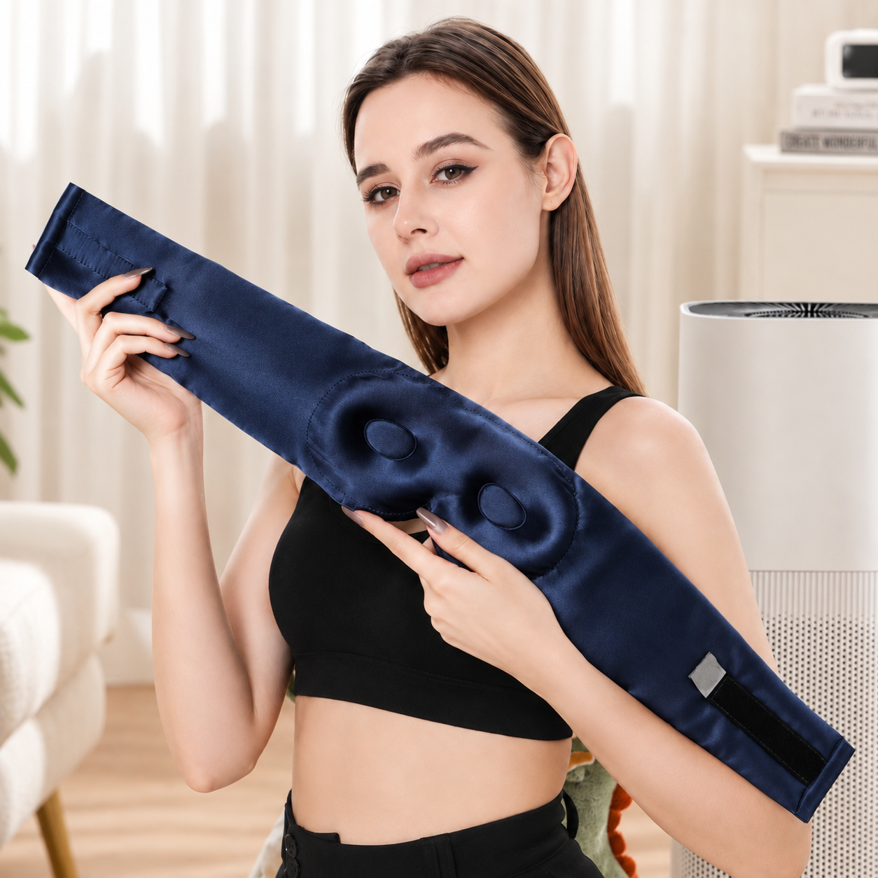 Female model holding the back of the Goodnight Co 3D Navy Blue Mulberry Silk Eye Mask to showcase its ergonomic contoured eye cups and adjustable strap designed for comfortable, pressure-free sleep.