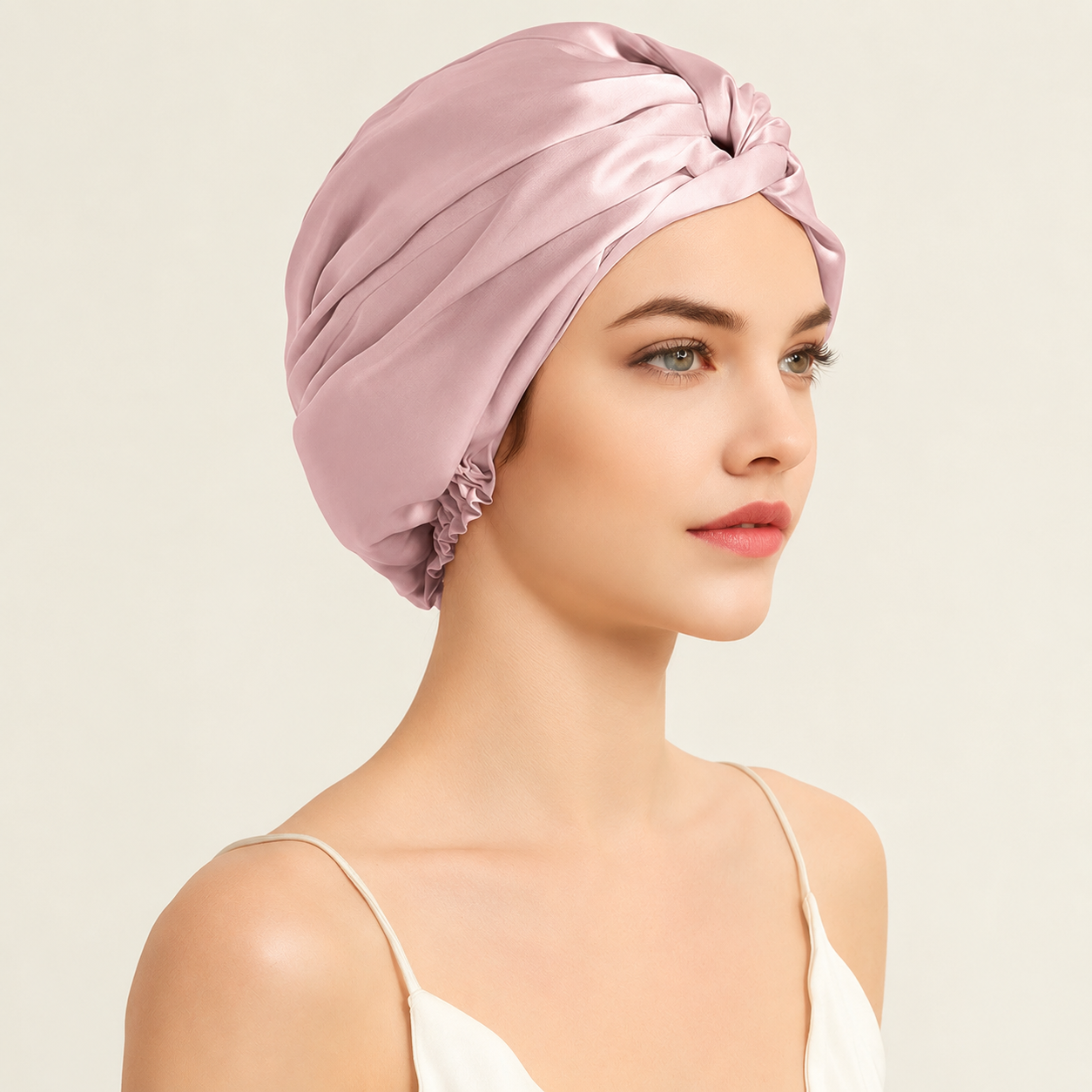 Woman wearing a Blush Petal Mulberry Silk Sleep Turban designed to keep hair smooth, hydrated and protected while sleeping.