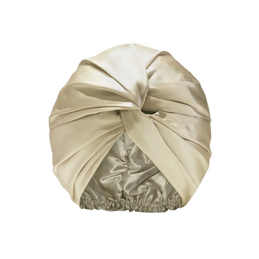 Champagne silk night bonnet – flat lay with soft lighting