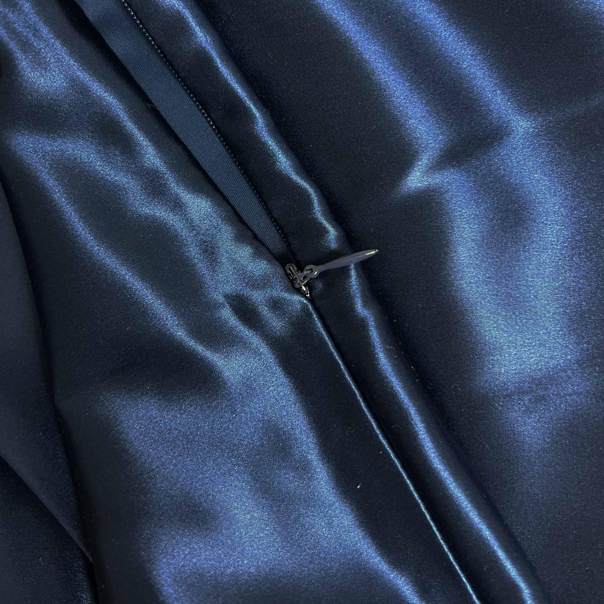 Close-up of navy blue silk pillowcase with a zipper