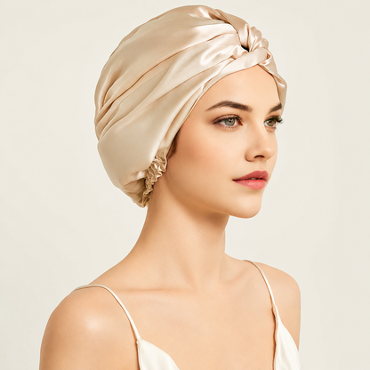 Woman wearing a Golden Glow Mulberry Silk Sleep Turban designed to keep hair smooth, hydrated and protected while sleeping.