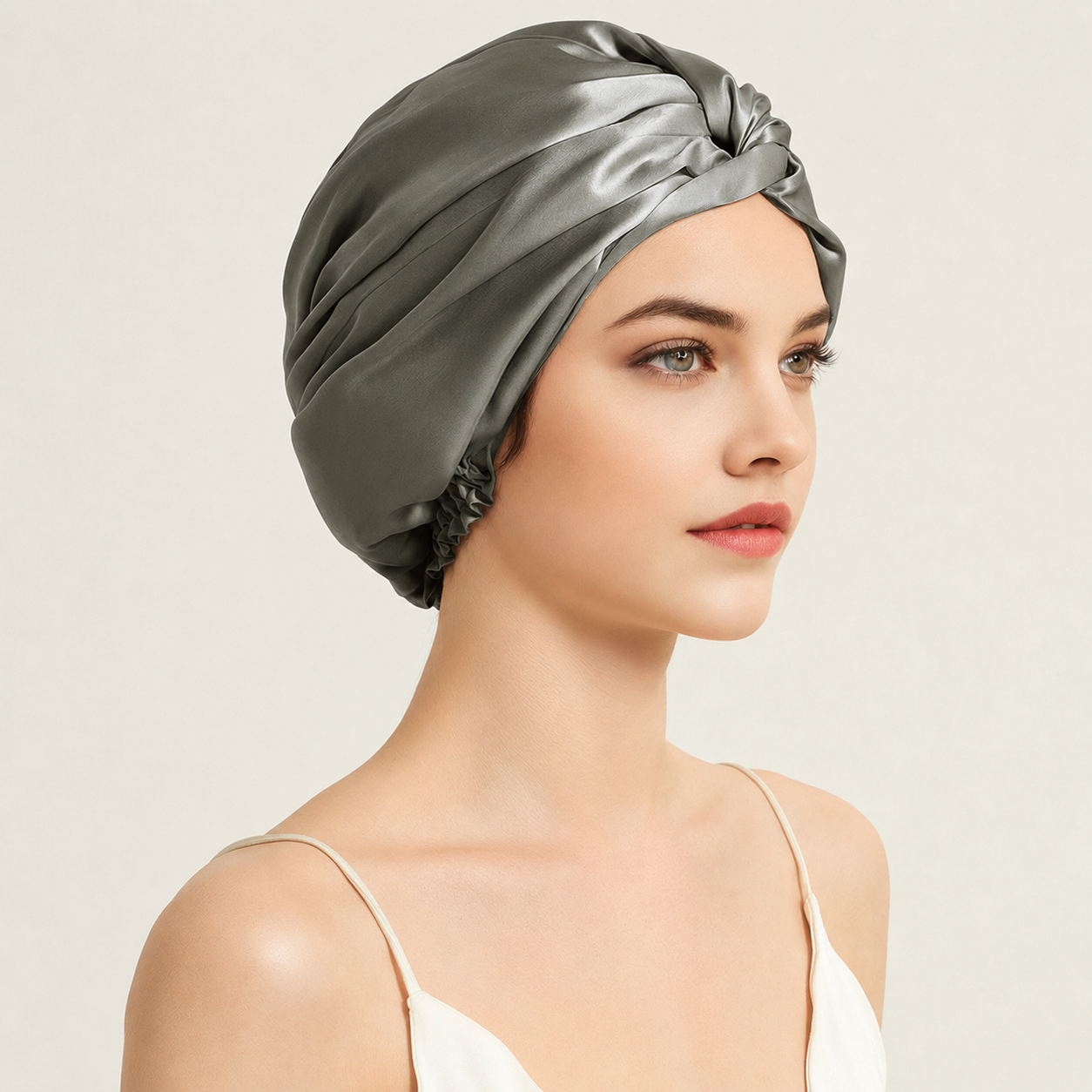 Woman wearing a Moonstone Grey Mulberry Silk Sleep Turban designed to keep hair smooth, hydrated and protected while sleeping.