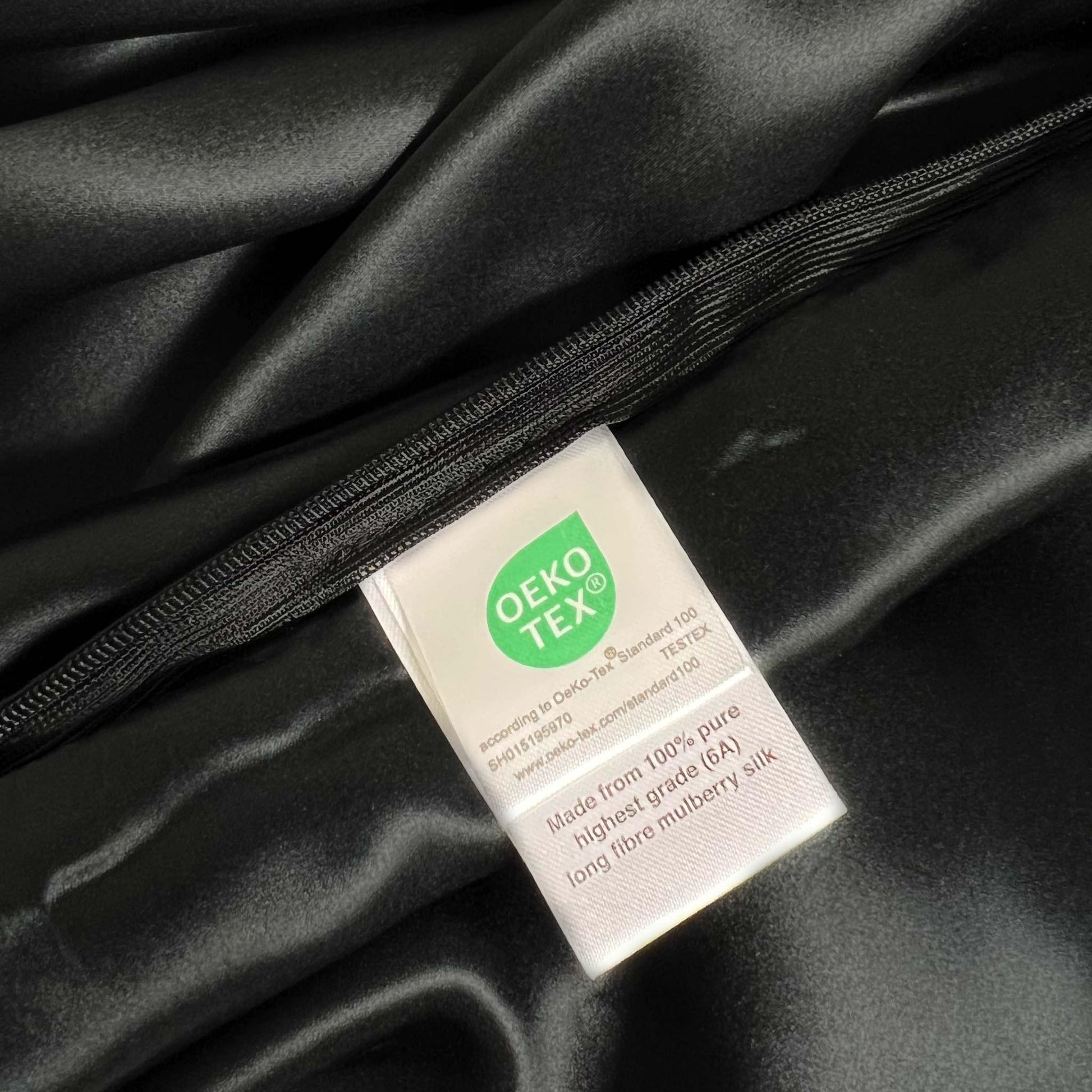 OEKO-TEX label on black silk pillow case
